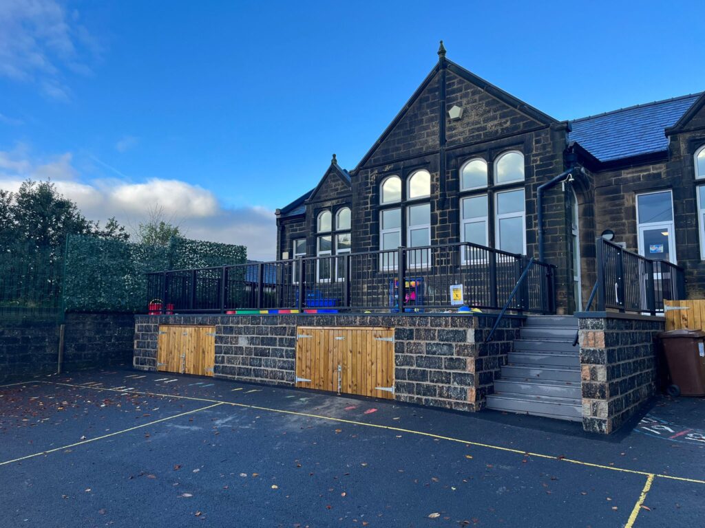 Completed school refurbishment in Lancaster by Ashbarn Construction, showing new steel railings, stone retaining wall and access steps